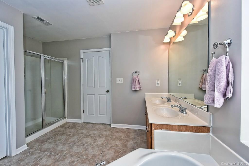 4719 Lapis Court Fort Mill, SC 29708 - Photo 19 of 24 a bathroom with a sink vanity and shower