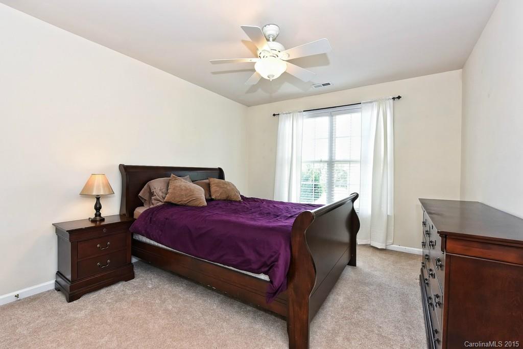 4719 Lapis Court Fort Mill, SC 29708 - Photo 20 of 24 a bedroom with a bed and a ceiling fan
