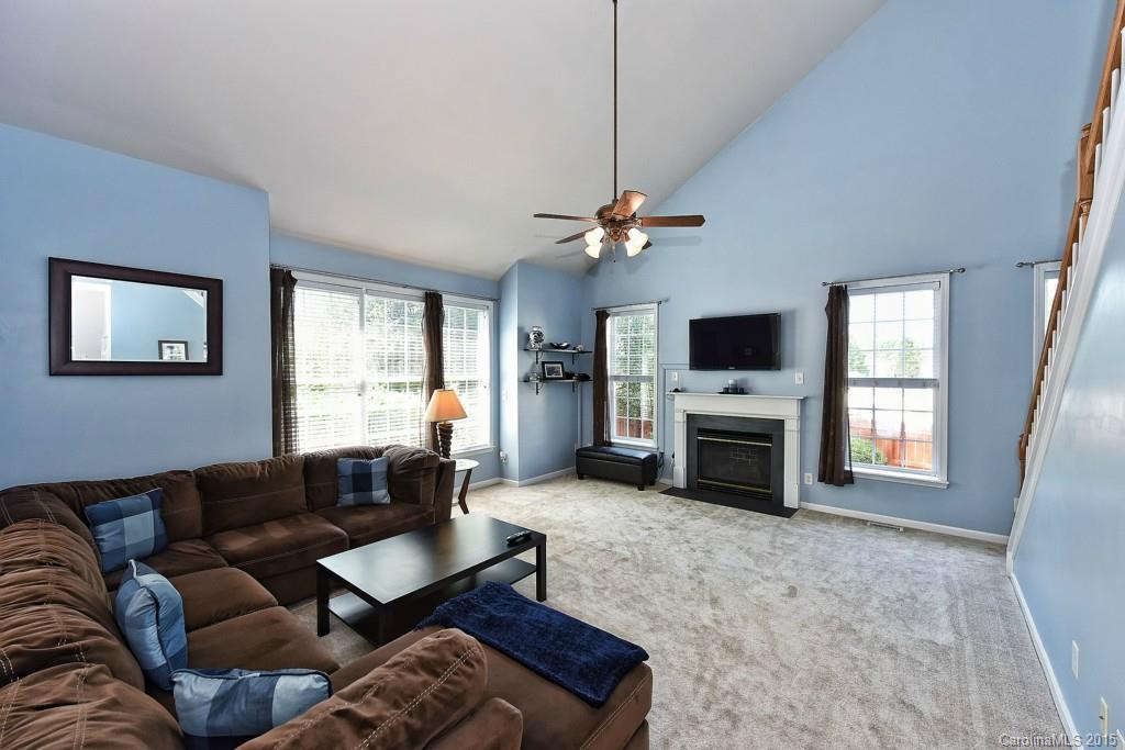 4719 Lapis Court Fort Mill, SC 29708 - Photo 10 of 24 a living room with furniture flat screen tv and a fireplace