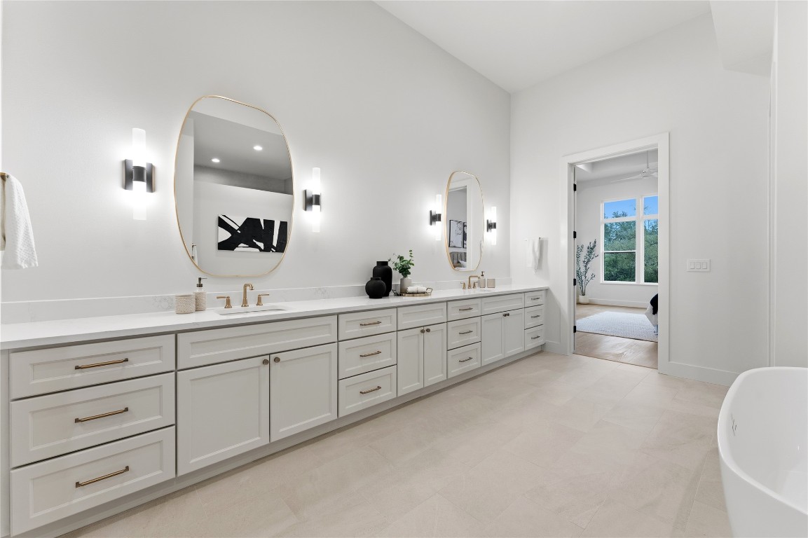 1283 Bunker Rnch Boulevard Dripping Springs, TX 78620 - Photo 12 of 22 a spacious bathroom with double sink and a mirror