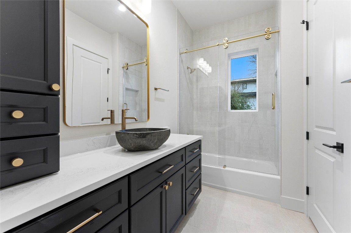 1283 Bunker Rnch Boulevard Dripping Springs, TX 78620 - Photo 15 of 22 a bathroom with a tub shower sink and mirror