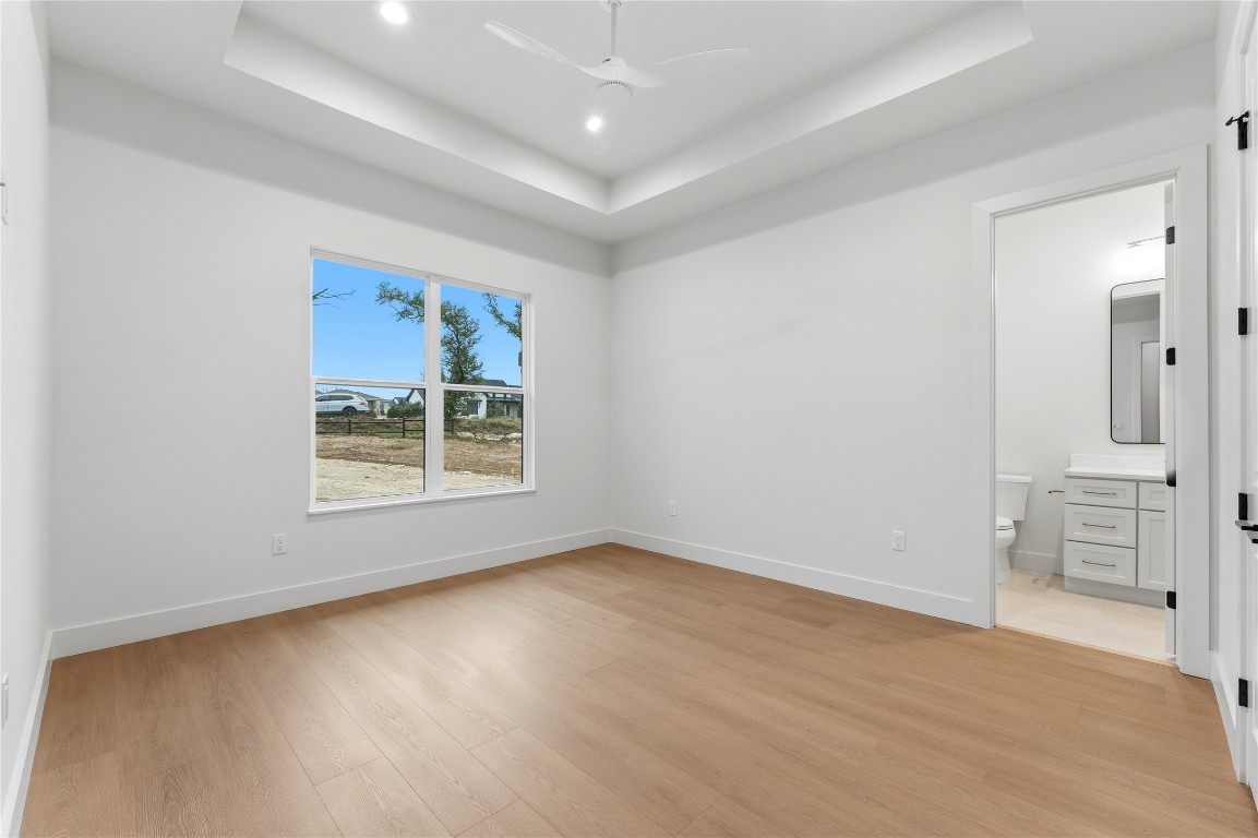1283 Bunker Rnch Boulevard Dripping Springs, TX 78620 - Photo 19 of 22 wooden floor in an empty room with a window