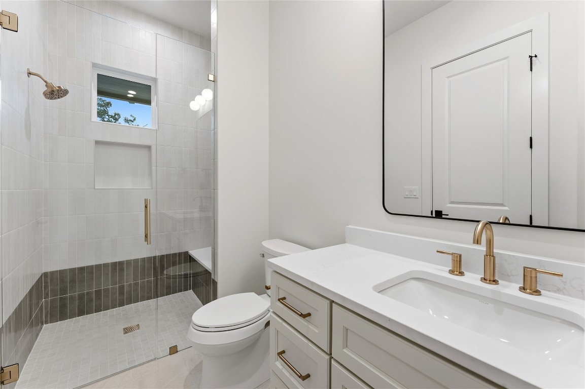 1283 Bunker Rnch Boulevard Dripping Springs, TX 78620 - Photo 20 of 22 a bathroom with a sink a toilet and shower