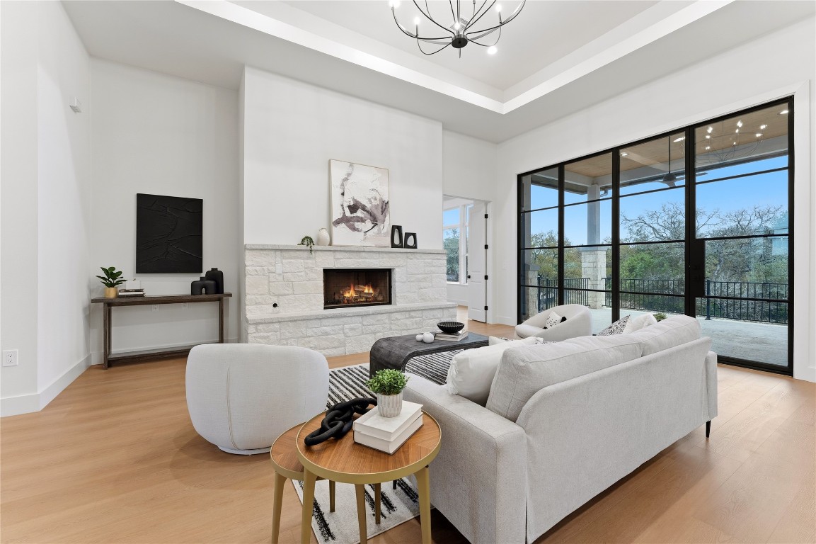 1283 Bunker Rnch Boulevard Dripping Springs, TX 78620 - Photo 7 of 22 a living room with furniture a fireplace and a flat screen tv