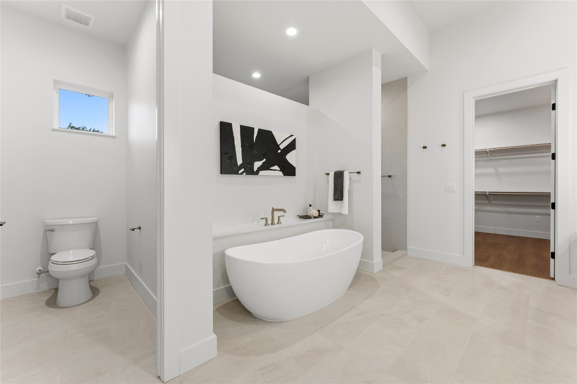1283 Bunker Rnch Boulevard Dripping Springs, TX 78620 - Photo 10 of 22 a bathroom with a toilet sink and mirror