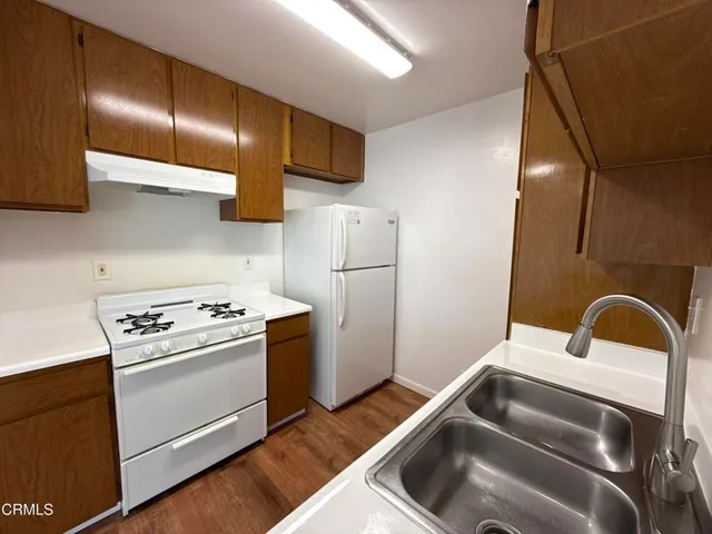a kitchen that has a sink and a stove