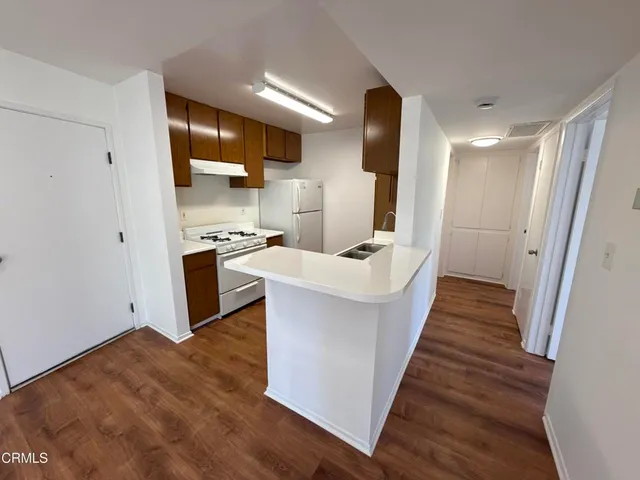 a view of kitchen with sink microwave and refrigerator