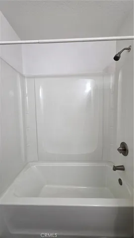 a bathroom with a shower and a bath tub
