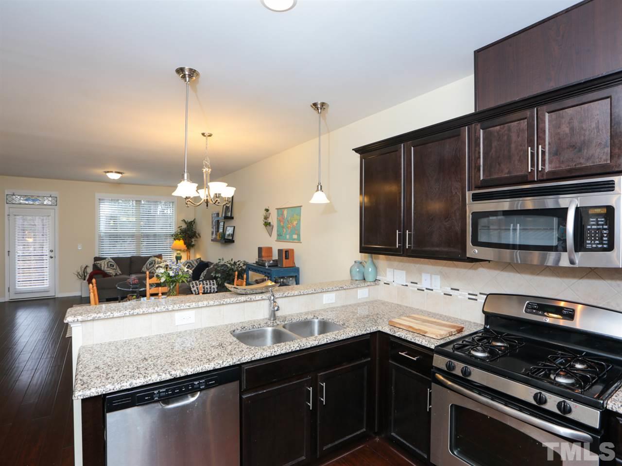 1543 Crafton Way Raleigh, NC 27607 - Photo 11 of 25 a kitchen with a sink and stove