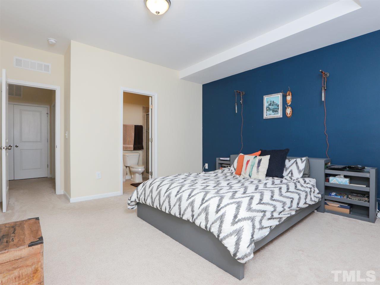1543 Crafton Way Raleigh, NC 27607 - Photo 13 of 25 a bedroom with a bed and a couch