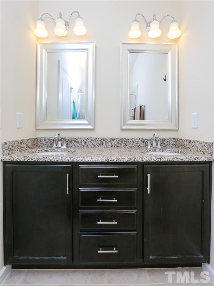 1543 Crafton Way Raleigh, NC 27607 - Photo 14 of 25 a bathroom with a sink vanity and mirror