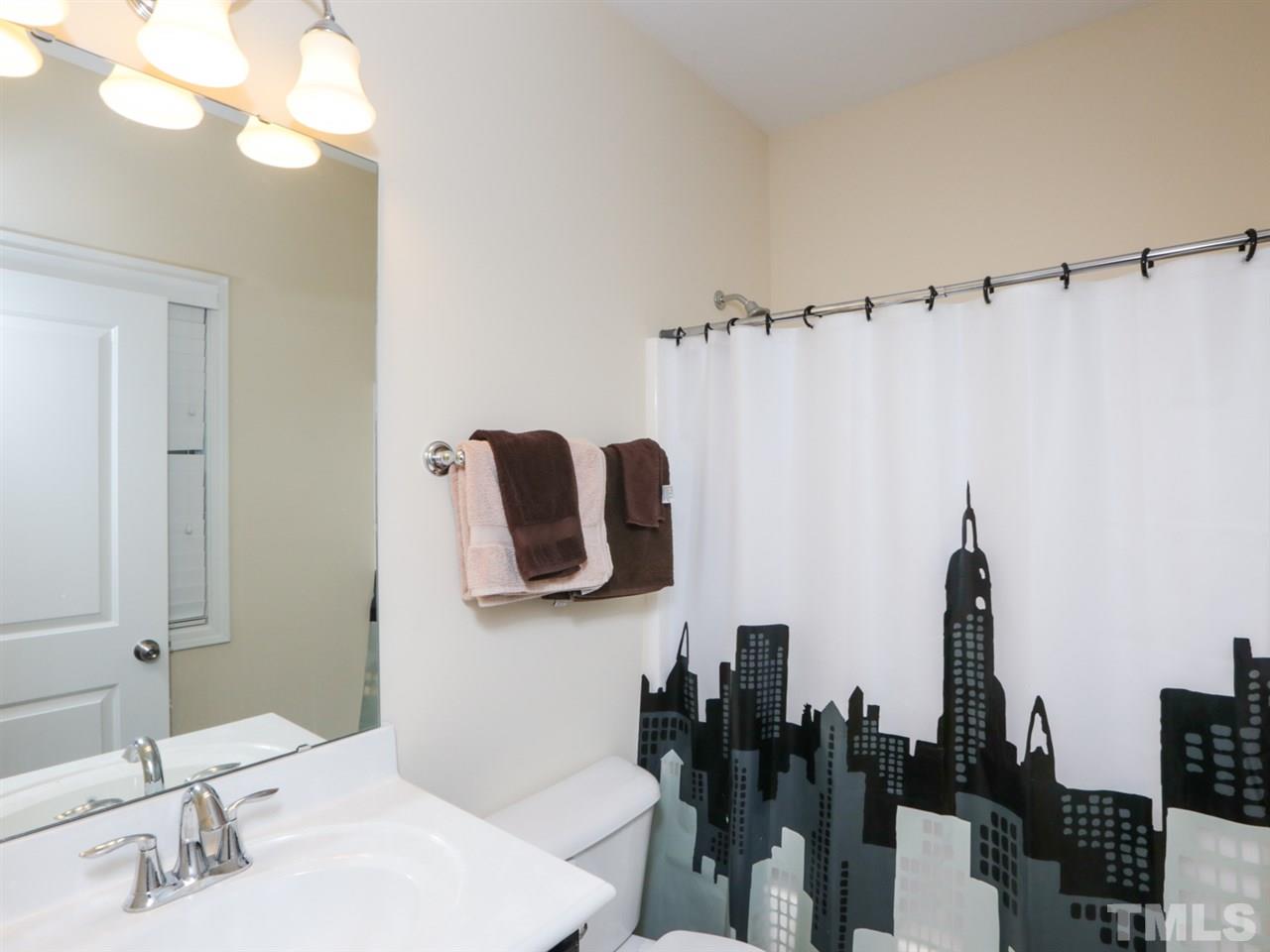 1543 Crafton Way Raleigh, NC 27607 - Photo 17 of 25 a bathroom with a sink and mirror