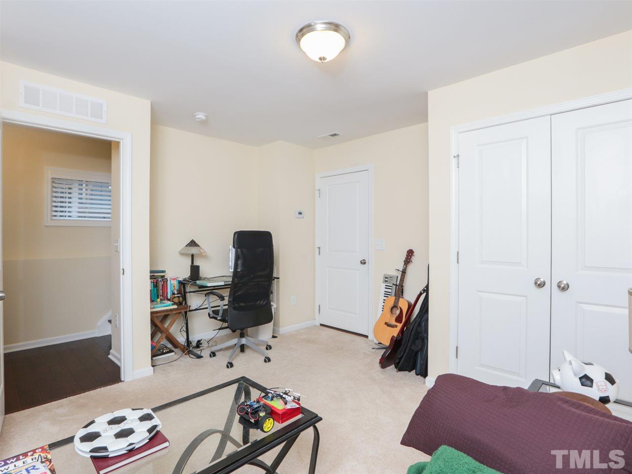 1543 Crafton Way Raleigh, NC 27607 - Photo 19 of 25 a room with furniture and a wooden floor