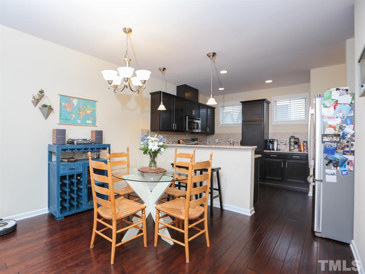 1543 Crafton Way Raleigh, NC 27607 - Photo 7 of 25 a view of a dining room with furniture and wooden floor
