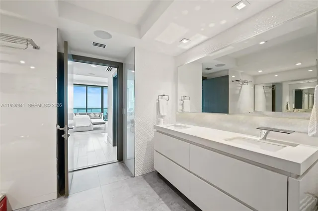 a spacious bathroom with a sink and a mirror