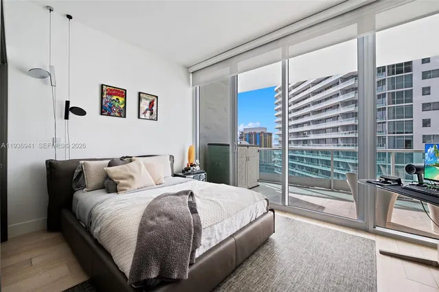 a bedroom with a large bed and a chandelier