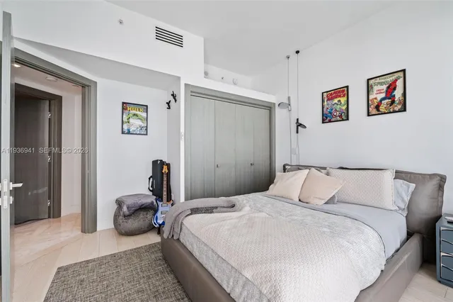 a bedroom with a bed and a couch