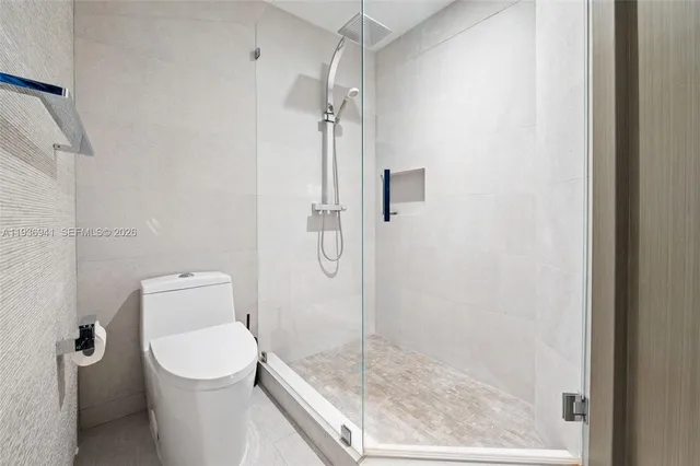 a bathroom with a shower a toilet and a sink