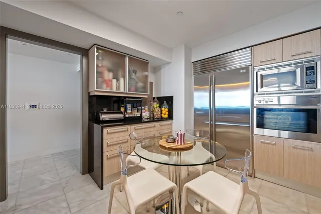 a kitchen with stainless steel appliances granite countertop a sink and a refrigerator