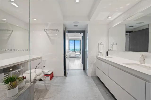 a bathroom with a tub sink and mirror