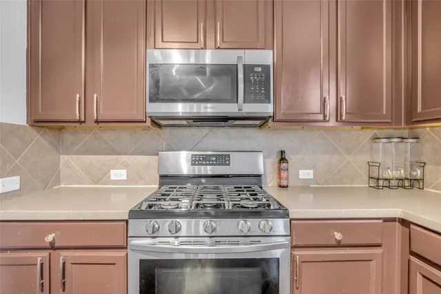 a kitchen with granite countertop a stove and a sink