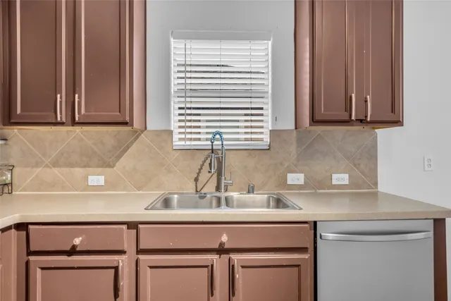 a kitchen with a sink cabinets and a window