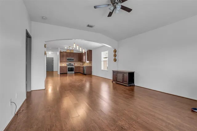 a view of a livingroom with hardwood floor and a ceiling fan