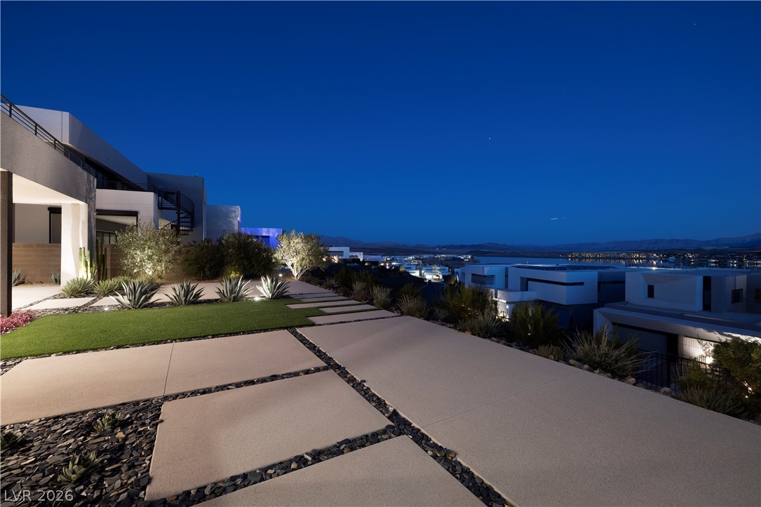 25 Falling Ridge Lane Henderson, NV 89011 - Photo 16 of 48 Discover a striking modern residence with sleek landscaping and breathtaking evening city vistas.