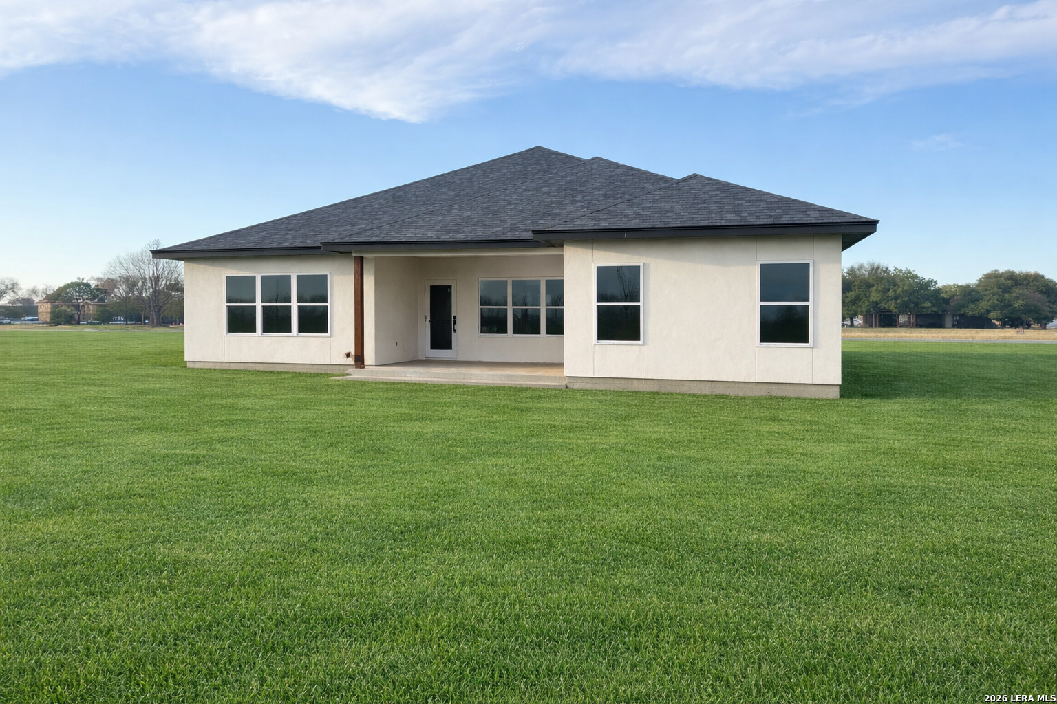 705 34th Street Hondo, TX 78861 - Photo 3 of 4 a front view of a house with a garden