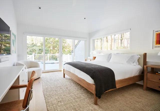 a spacious bedroom with a bed and a large window