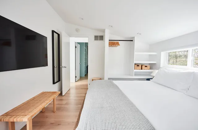 a large white bed in a white room