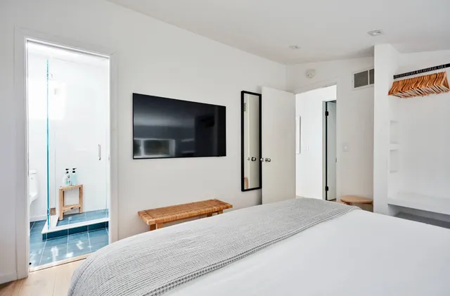 a bedroom with a bed and a flat screen tv