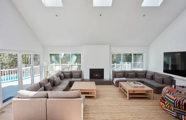 a living room with furniture window and a fireplace