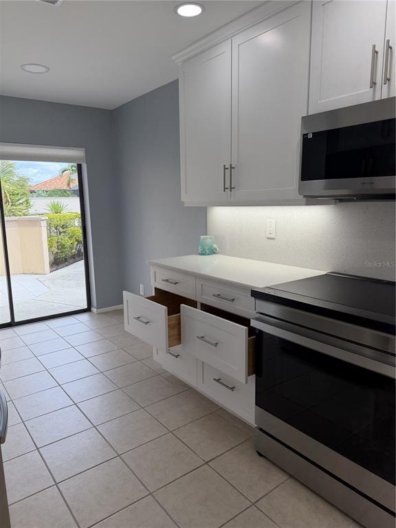 2004 Longpointe Circle Venice, FL 34293 - Photo 27 of 54 a kitchen with stainless steel appliances a sink stove and microwave