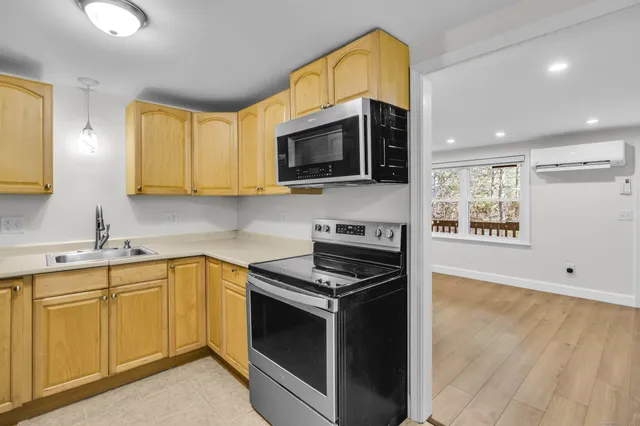 a kitchen with stainless steel appliances a stove a microwave and sink
