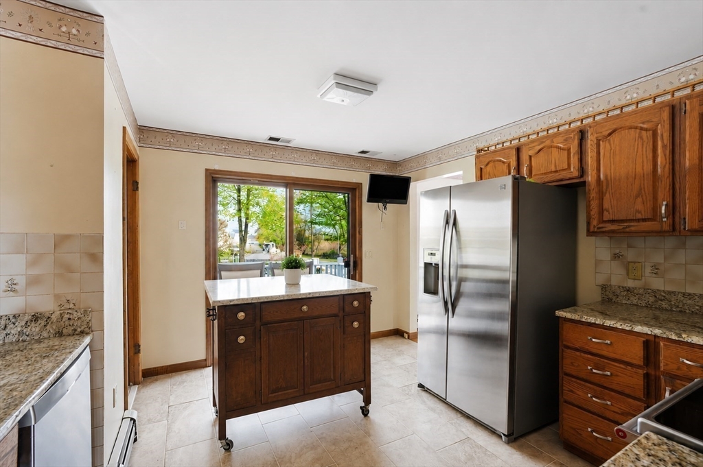 67 Wituwamat Road Weymouth, MA 02191 - Photo 9 of 42 a kitchen with stainless steel appliances granite countertop a refrigerator and a stove