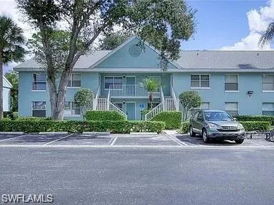 a car parked in front of white house