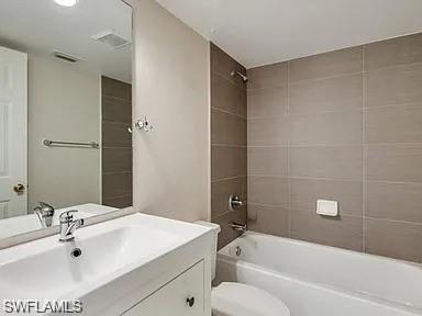 109 Wading Bird Circle, Unit V102 Naples, FL 34110 - Photo 11 of 15 a bathroom with a sink toilet and shower