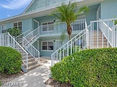 109 Wading Bird Circle, Unit V102 Naples, FL 34110 - Photo 2 of 15 front view of a house with a deck