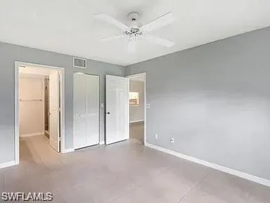 a view of a room with a ceiling fan and shower
