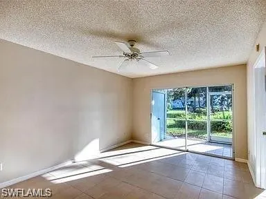 a view of a livingroom with a ceiling fan and window