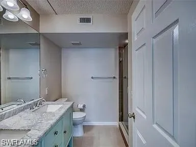 a bathroom with a granite countertop sink toilet and shower
