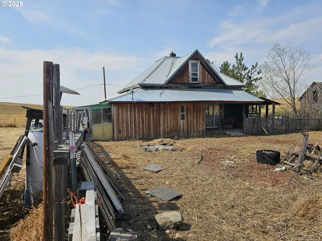 a view of a house with wooden fence
