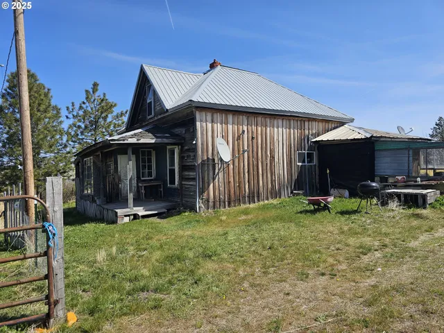 a view of a house with backyard porch and sitting area