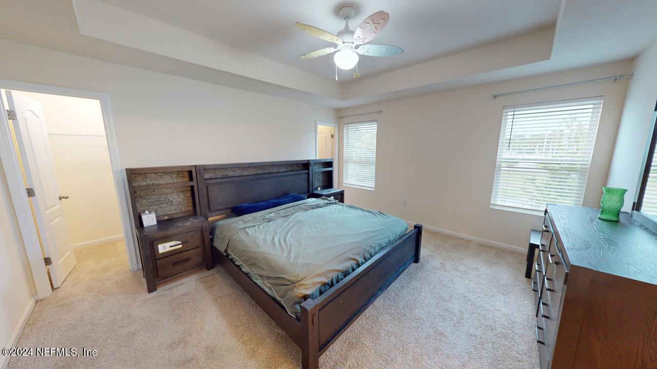 86013 Club Car Place Yulee, FL 32097 - Photo 15 of 28 a bedroom with a bed and a table in it