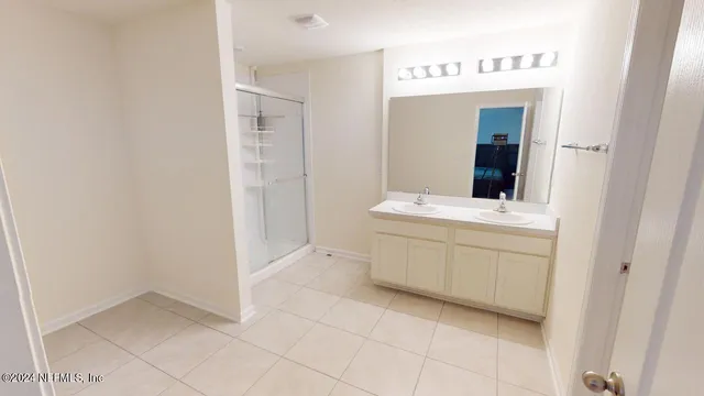 a bathroom with a sink vanity and mirror
