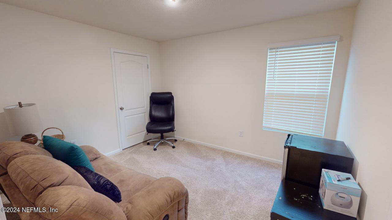 86013 Club Car Place Yulee, FL 32097 - Photo 19 of 28 a bedroom with a bed and a chair