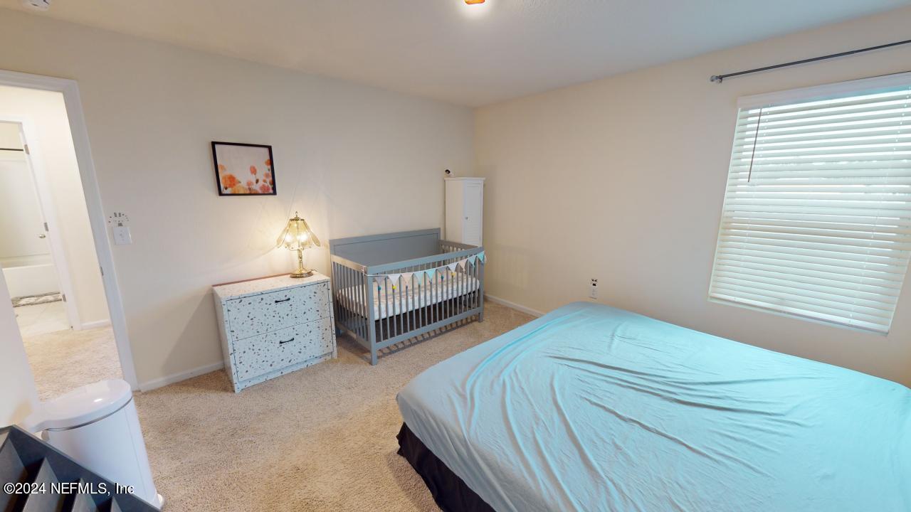 86013 Club Car Place Yulee, FL 32097 - Photo 20 of 28 a bedroom with a bed and a window