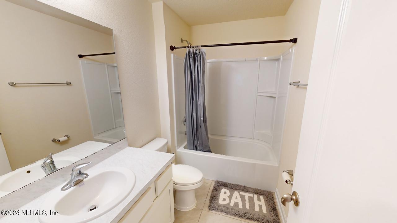 86013 Club Car Place Yulee, FL 32097 - Photo 22 of 28 a bathroom with a sink toilet and shower