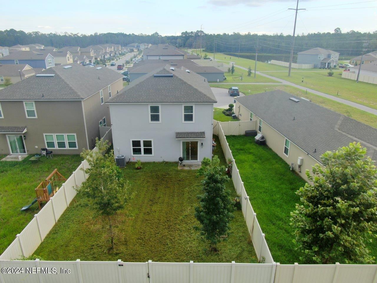 86013 Club Car Place Yulee, FL 32097 - Photo 25 of 28 an aerial view of a house with a yard